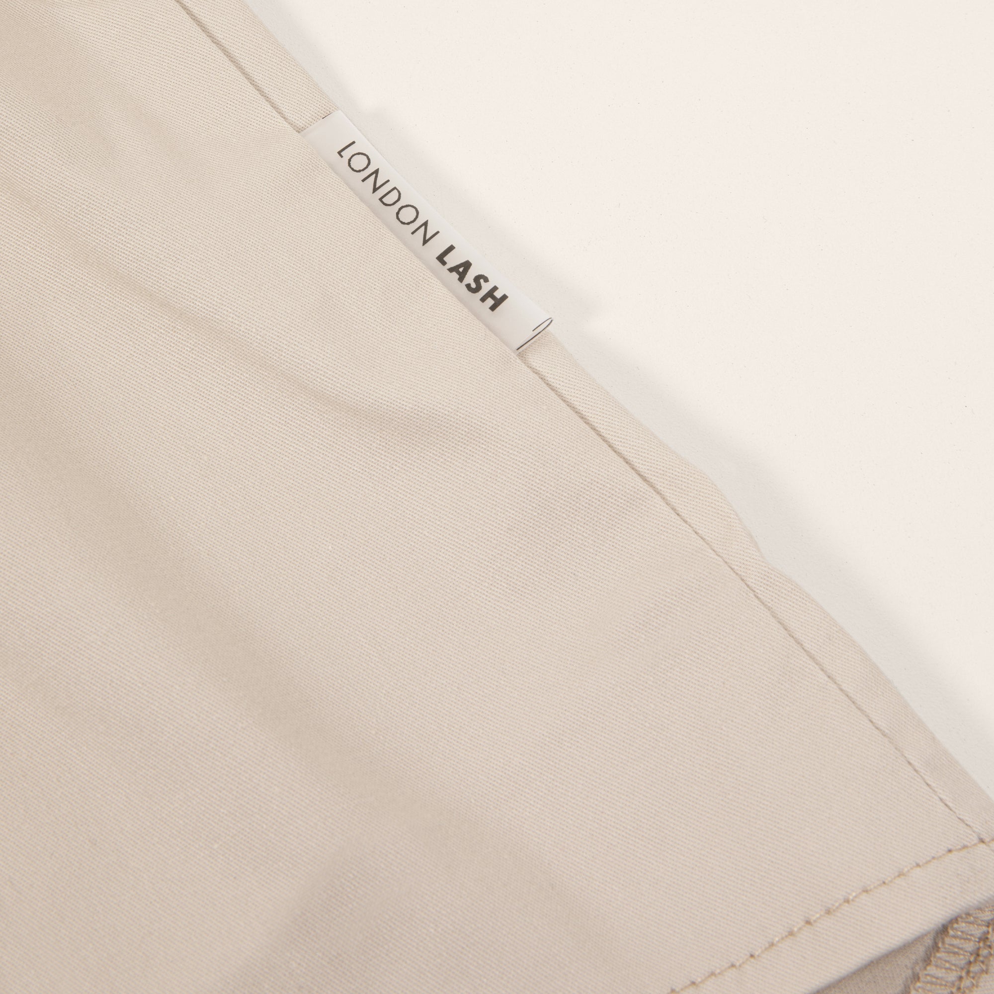 London Lash branded tag on beige garment