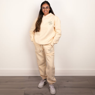 Woman wearing a cream loungewear set for working in a beauty salon