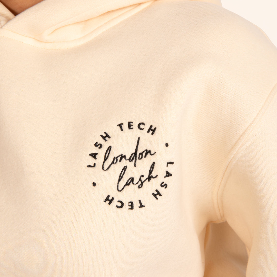 Lash Tech cream hoodie with an embroidered London Lash logo on the front